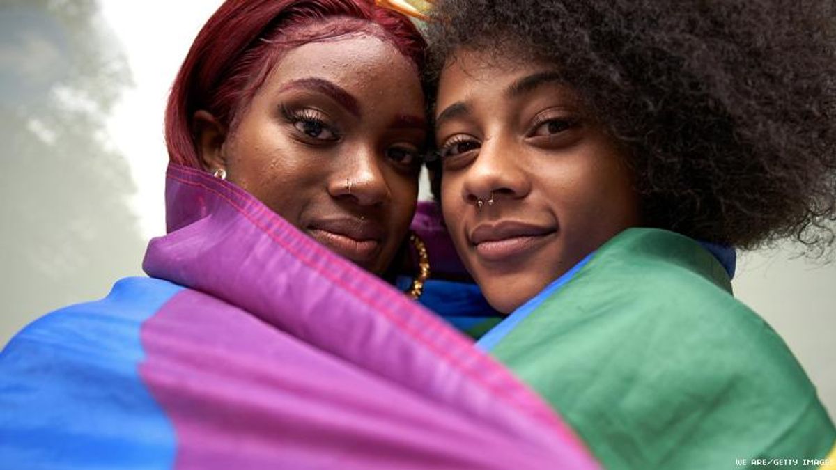 Two Black Lesbians in a Pride Flag