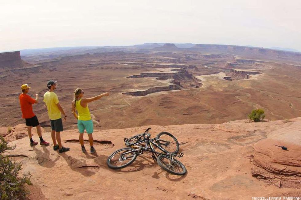 Two people with bikes explore a desert landscape in documentary National Park Adventure