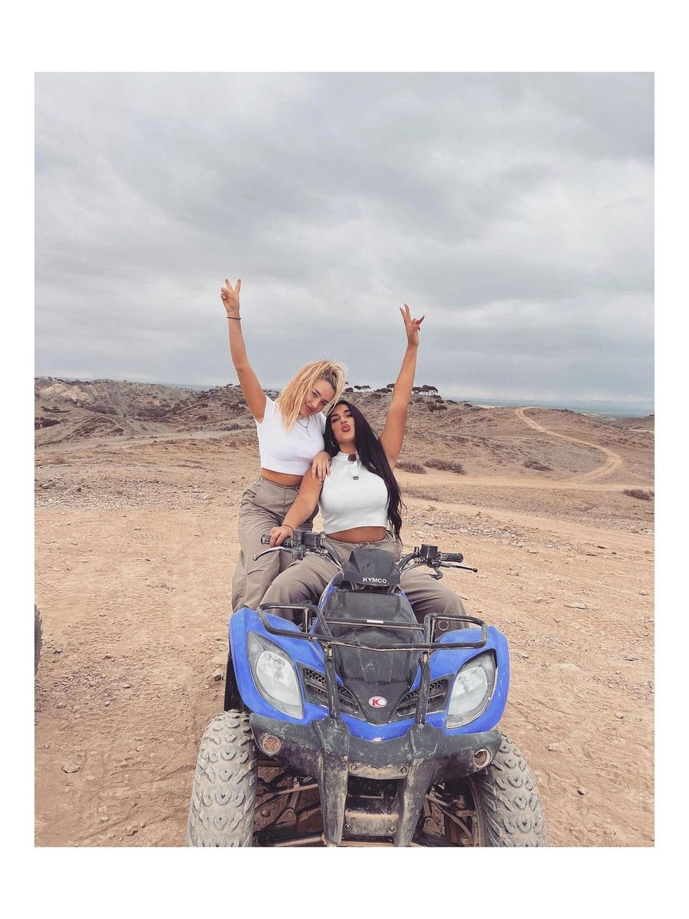 two women on an ATV in desert