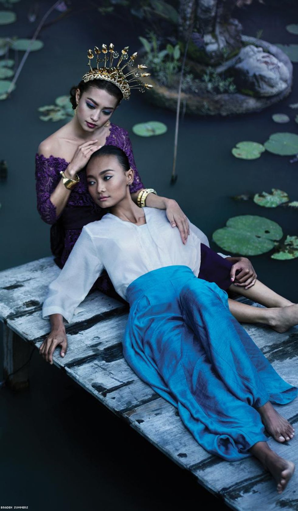 two women together on pond in Bali Indonesia by Braden Summers