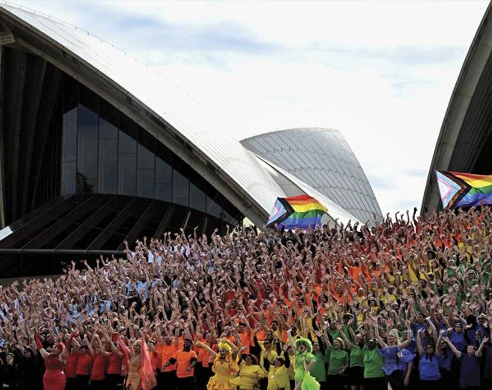 Volunteers make the colors of the progress LGBTQ+ flag in Sydney's iconic opera house