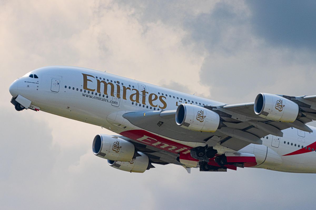 white and red Emirates passenger plane in the sky