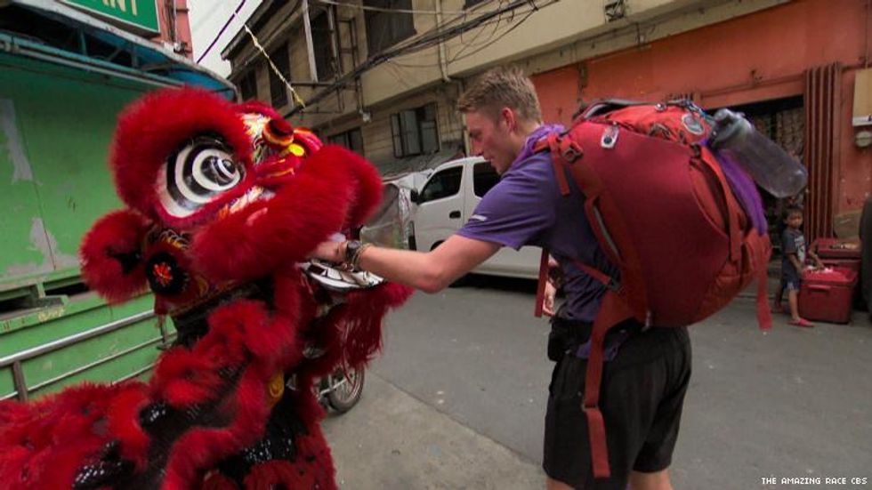Will and James of 32nd The Amazing Race with a Chinese dragon in Manila