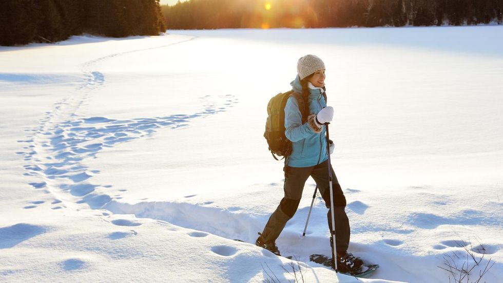woman snowshoeing on a trail
