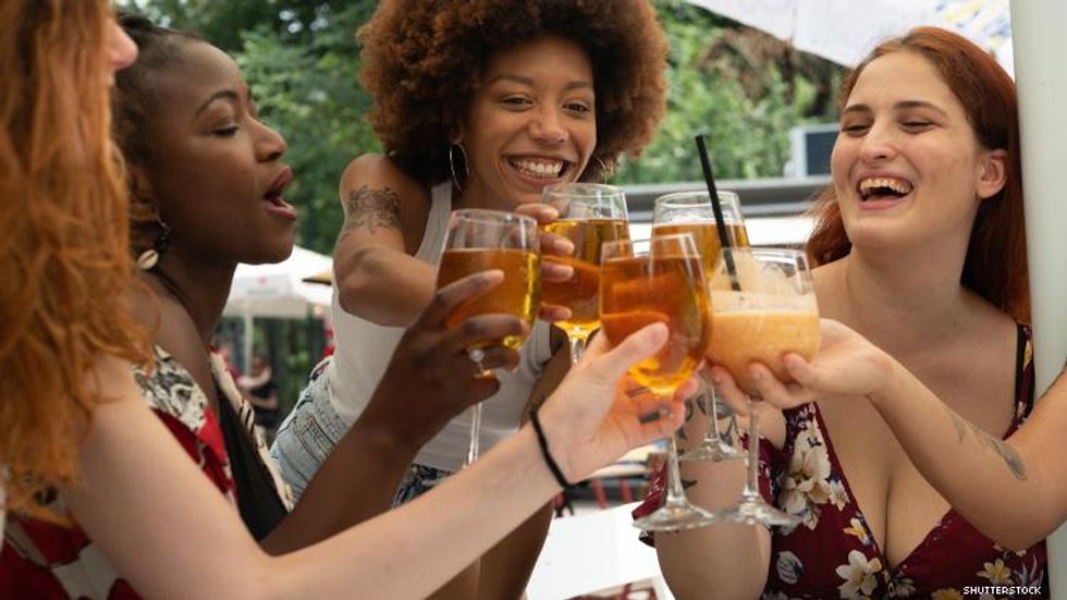 Women cheering with drink glasses