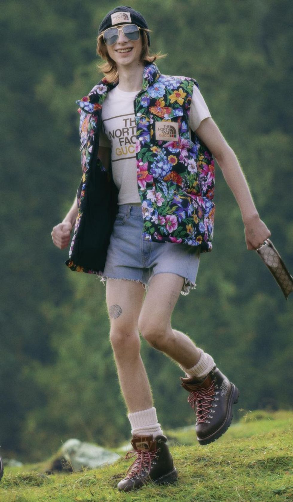 Young person wearing North Face x Gucci hiking