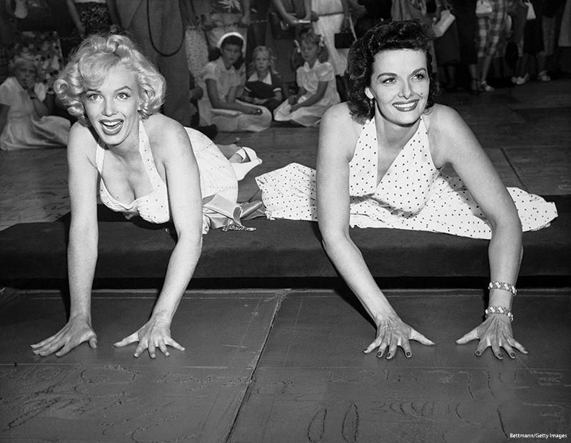 Glamour queens Marilyn Monroe and Jane Russell, making their imprint on the walk of fame in front of the Chinese Theatre, after working together in Gentlemen Prefer Blondes