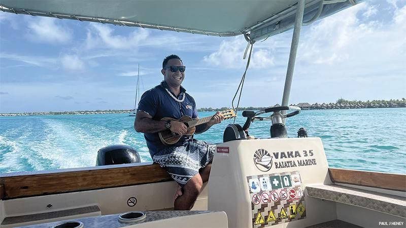 Bora Bora Cultural Lagoon Tours guide Narii serenading the couple with Tahitian songs while strumming his ukulele