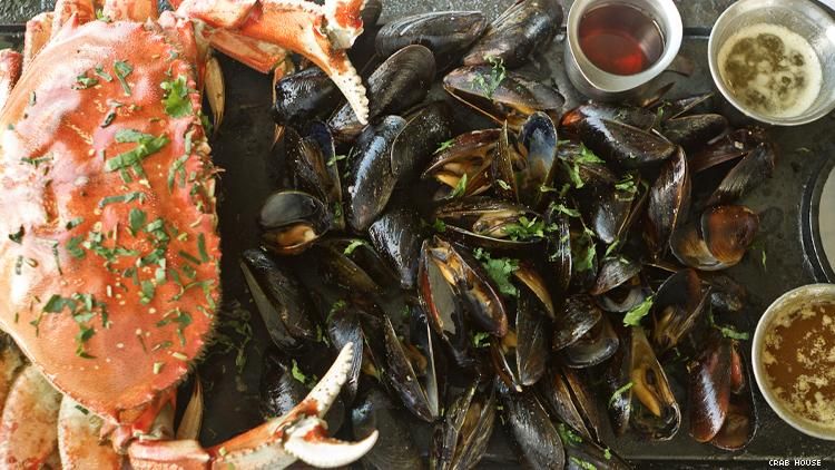 a platter with cooked crab and mussels 