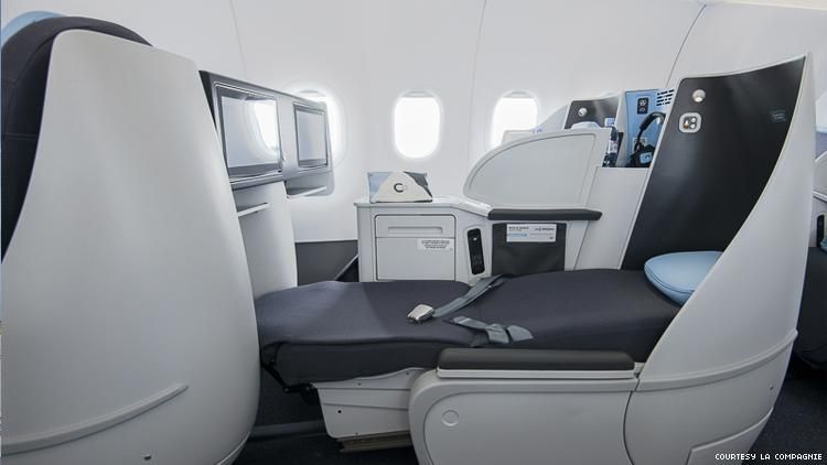 la compagnie airline cabin with fully reclined seat bed