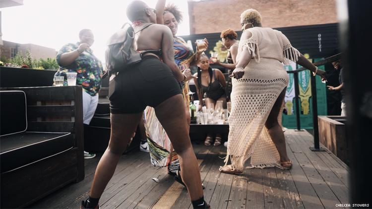 Black lesbians dancing at a Detroit rooftop party