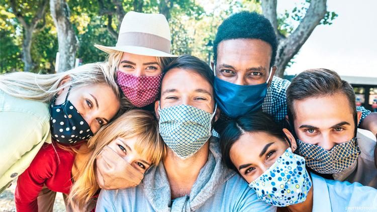 group of multicultural friends wearing masks taking a selfie
