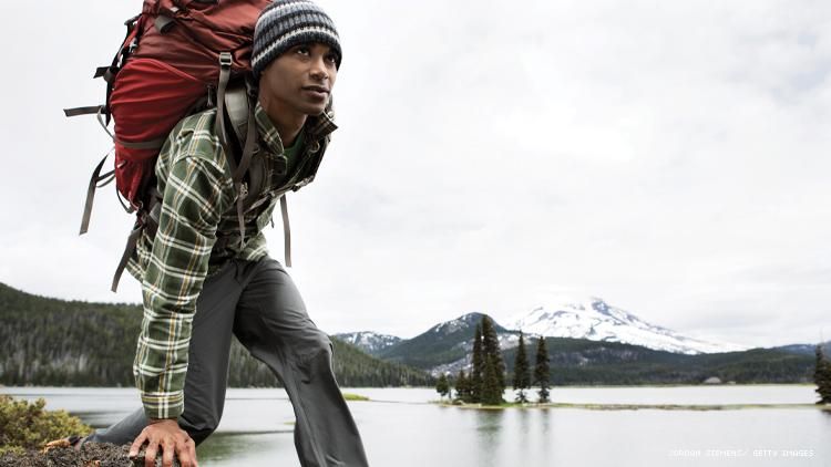 A Black man hiking in the mountains