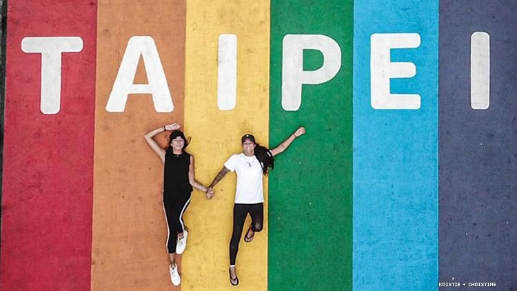 Lesbian couple from above, lying on rainbow Taipei crosswalk