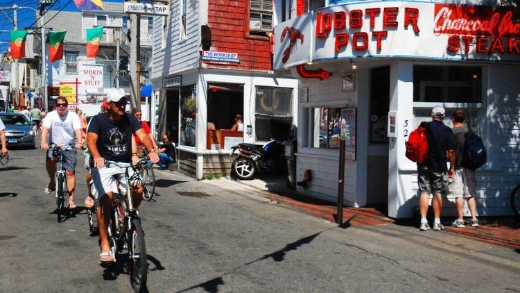 P-town commercial street with two male bike riders