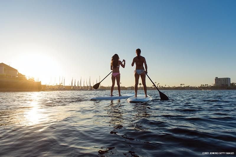 Two women paddleboarding, Mission Bay, San Diego