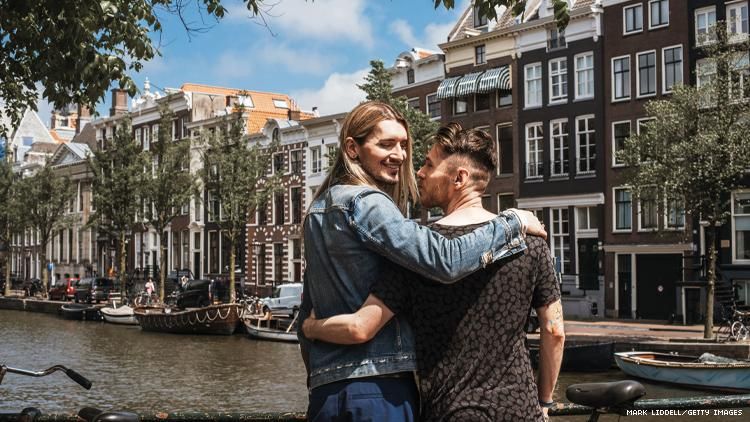 Gay male couple overlook a canal in Amsterdam