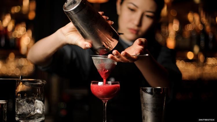 Asian woman bartender with cocktail