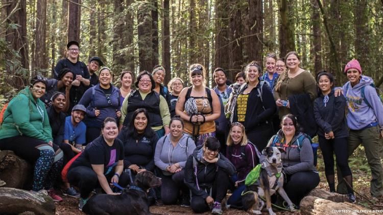 Unlikely Hikers diverse group of mostly women posing in woods