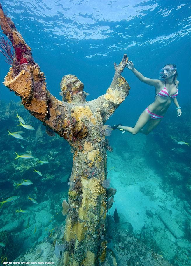 Woman snorkeling next to Key Largo's underwater Christ figure