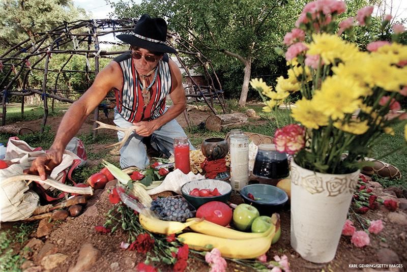 David Young of Boulder, Colorado spreads out offerings upon an altar to be used during a Native American healing ceremony. Young is part of a support group for LGBTQ+ American Indians called the Two-Spirit Society