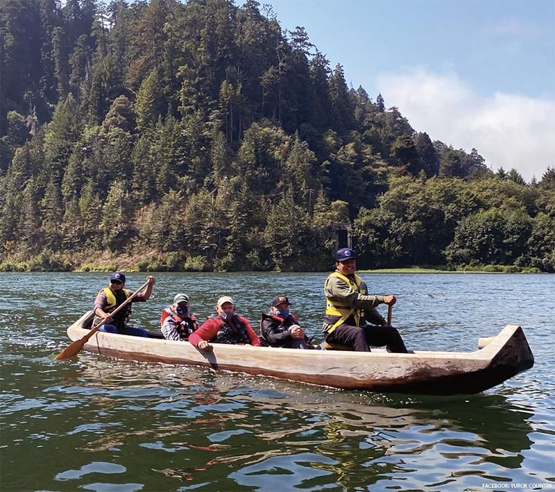 Traditional dugout canoe in motion
