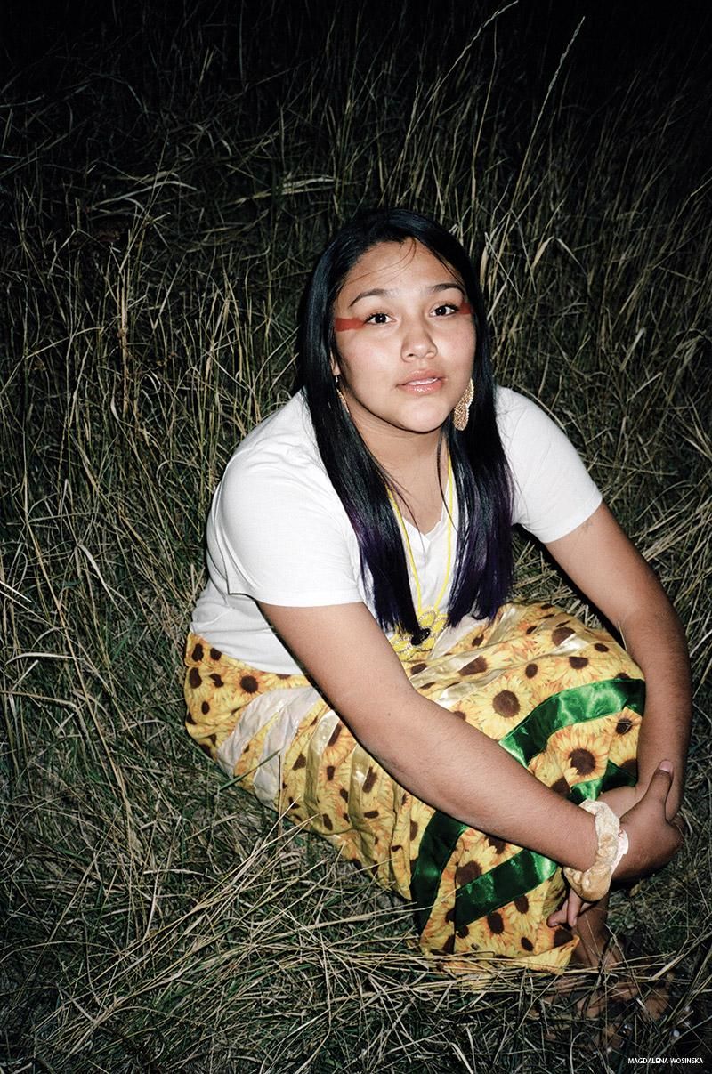 An unnamed Two-Spirit Lakota tribal member in a field at night