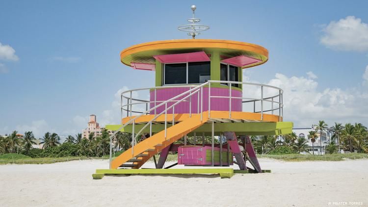 A round pink and orange lifeguard tower on a Miami beach