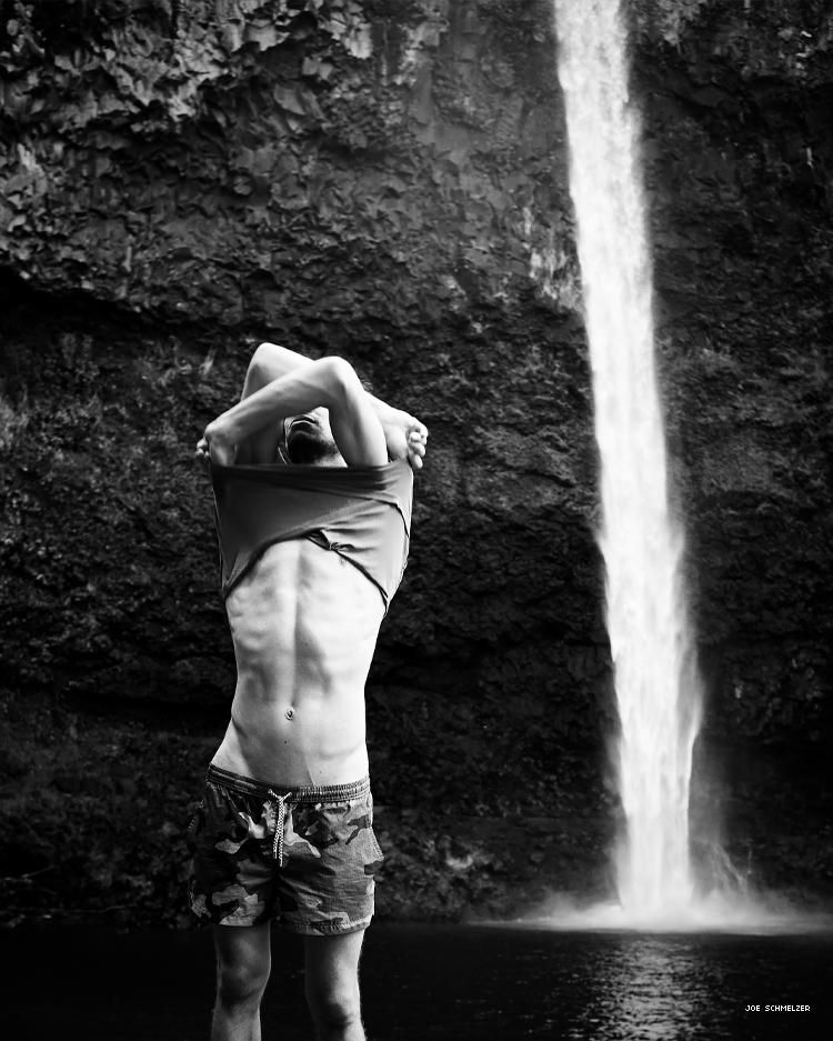 Life With Nick by Joe Schmelzer Nick taking off his shirt near waterfall