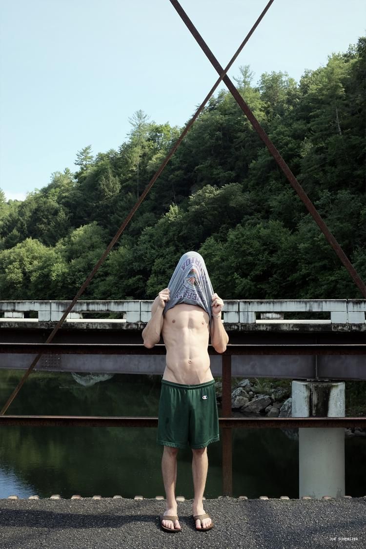 Life With Nick by Joe Schmelzer Nick pulls his shirt over his face on a bridge