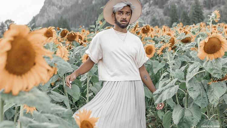 Omar in a skirt in sunflower field